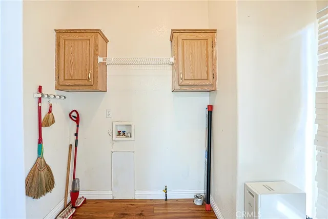 a view of storage and utility room with wooden floor