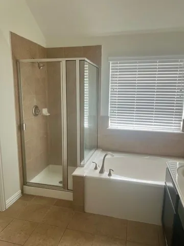 a bathroom with a bathtub and a shower