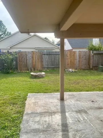 a front view of a house with a yard and fence
