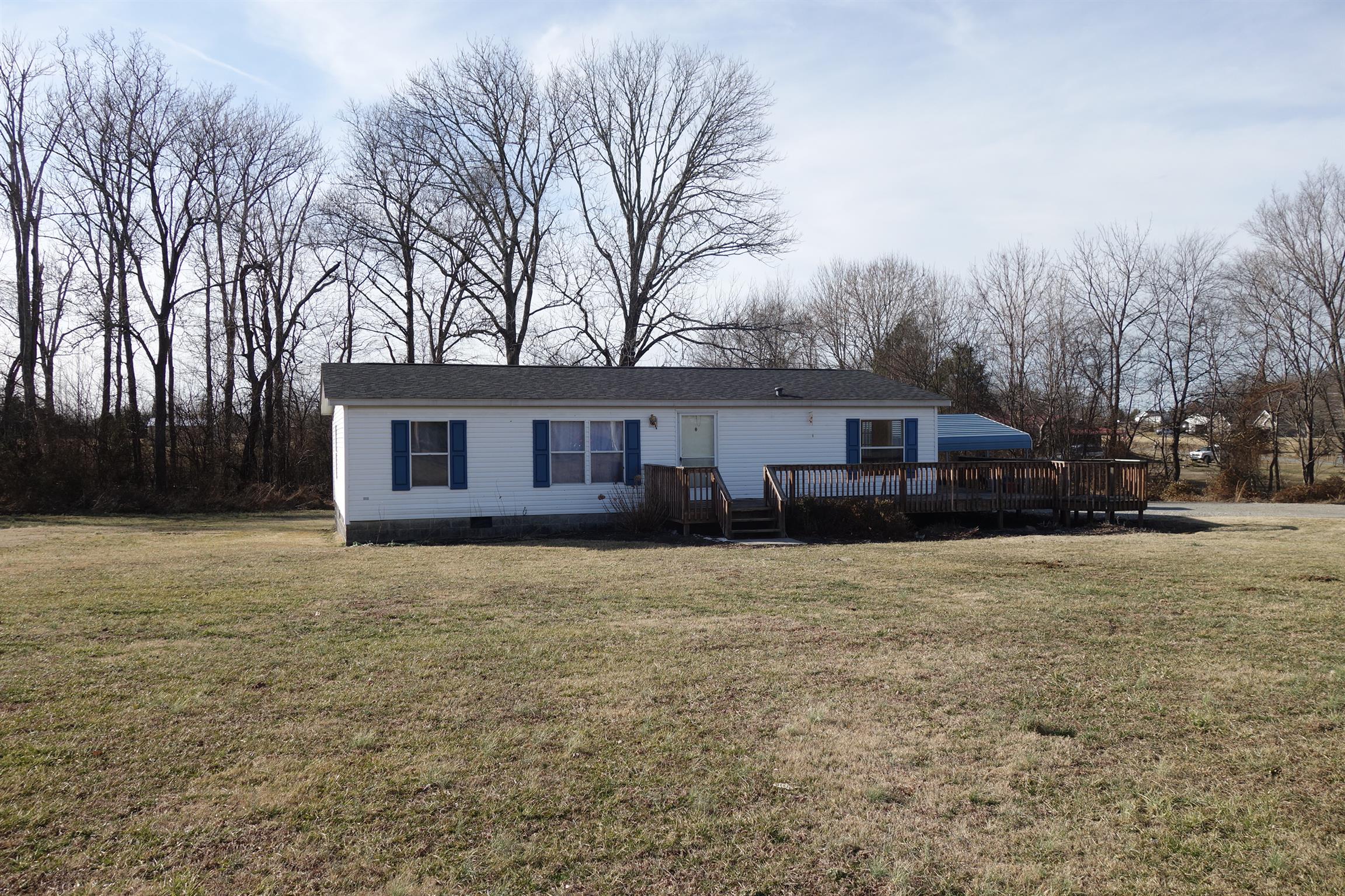 114 East Biggs Road Portland, TN 37148 - Photo 1 of 26 a front view of a house with yard covered with trees