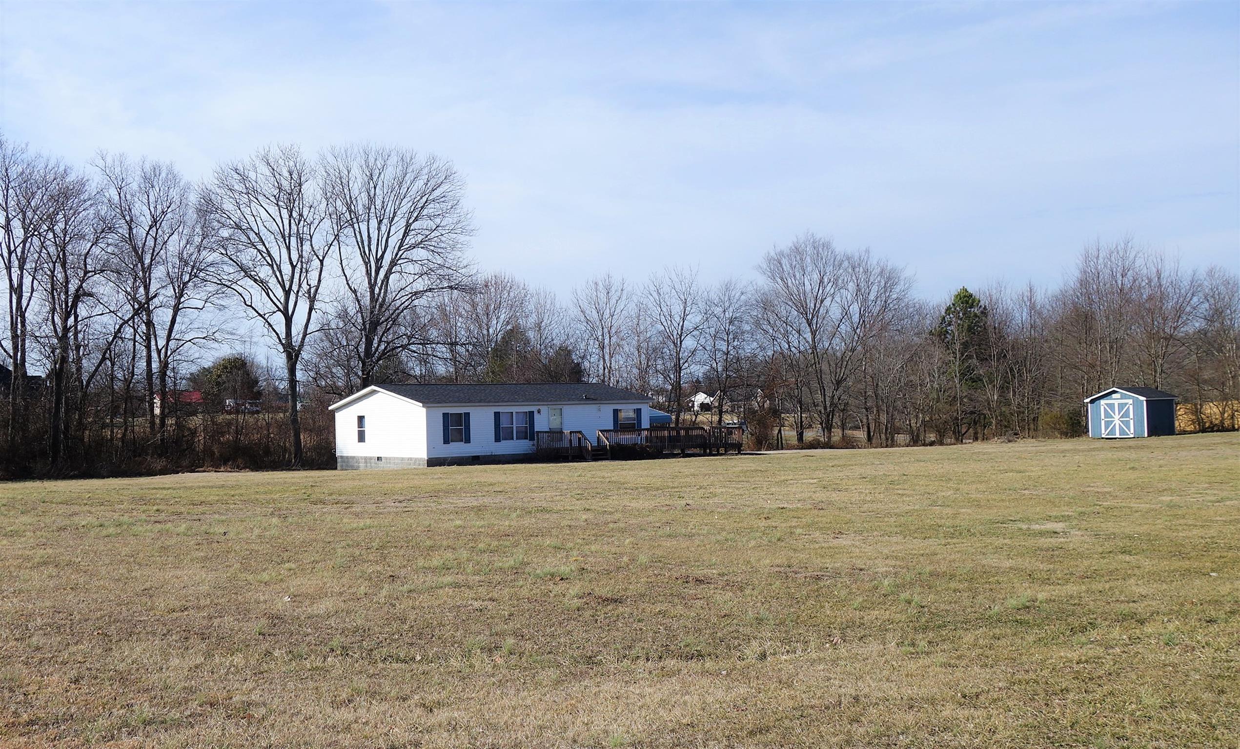 114 East Biggs Road Portland, TN 37148 - Photo 7 of 26 a view of white house with a yard and trees
