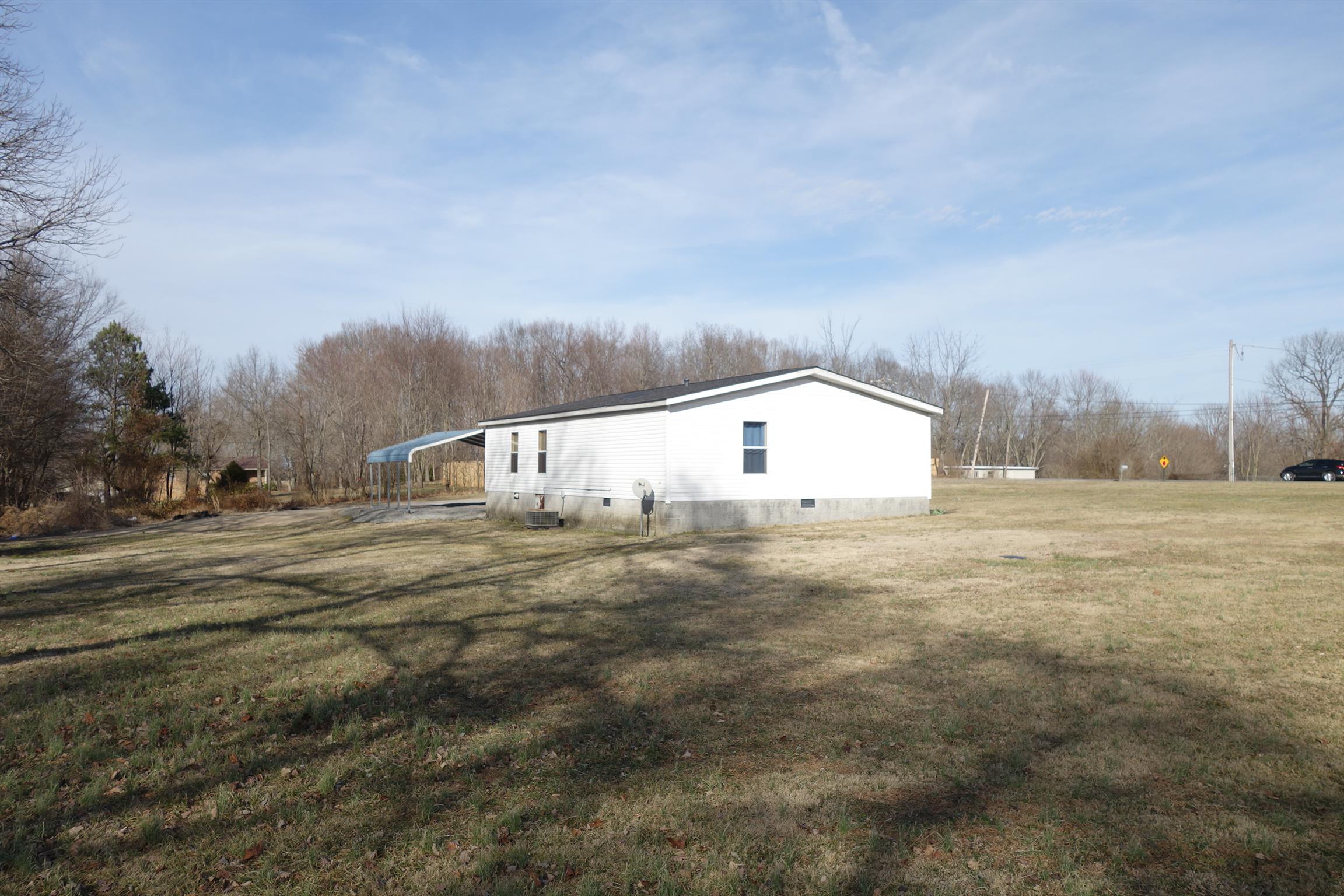 114 East Biggs Road Portland, TN 37148 - Photo 10 of 26 a view of a big house with a big yard and large trees