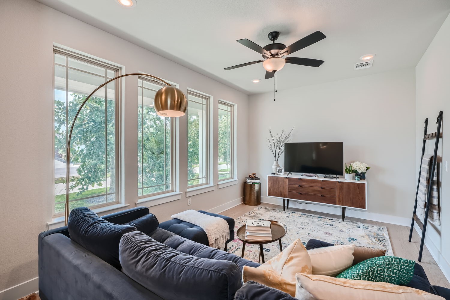 8319 Laughlin Lane Austin, TX 78744 - Photo 8 of 26 Upon entering, you'll be greeted by beautiful light wood floors that flow through the open-concept living areas, where large windows fill the space in natural light.