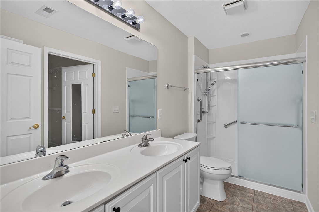 134 Life Style Lane Anderson, SC 29621 - Photo 22 of 44 Dual vanities and a modern walk-in shower elevate this well-appointed bathroom.