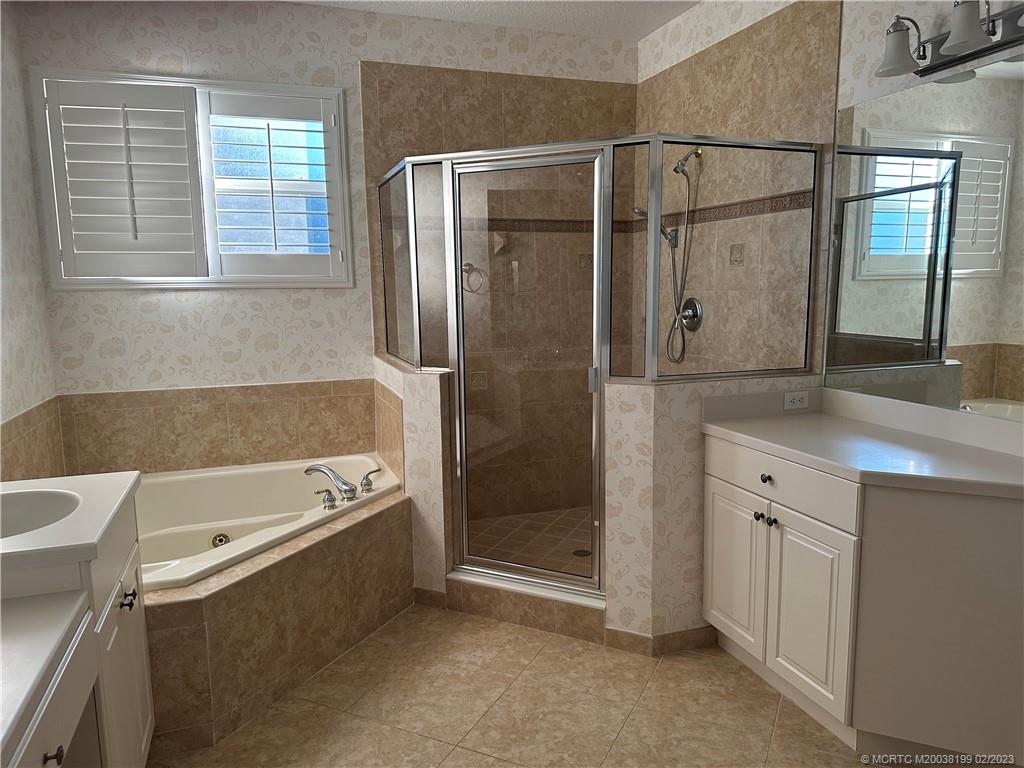 270 Southwest Walking Path Stuart, FL 34997 - Photo 13 of 25 a bathroom with a tub sink and mirror