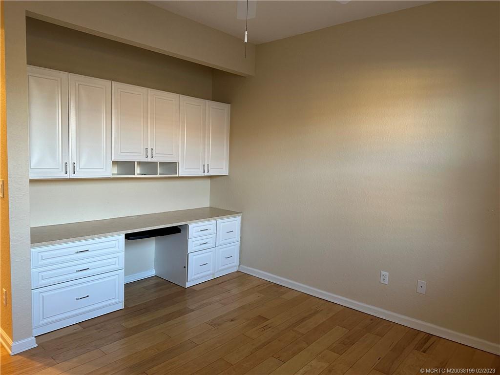 270 Southwest Walking Path Stuart, FL 34997 - Photo 15 of 25 a kitchen with granite countertop white cabinets and a wooden floor