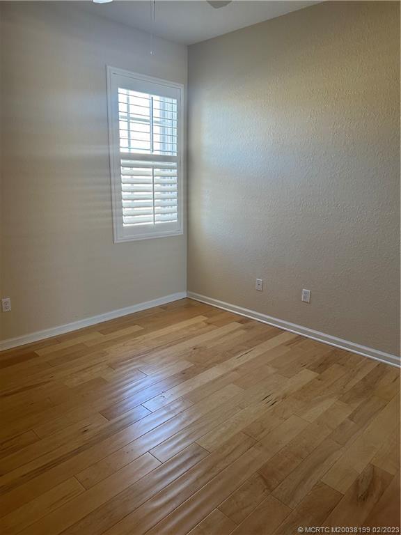 270 Southwest Walking Path Stuart, FL 34997 - Photo 16 of 25 a view of an empty room with wooden floor and a window