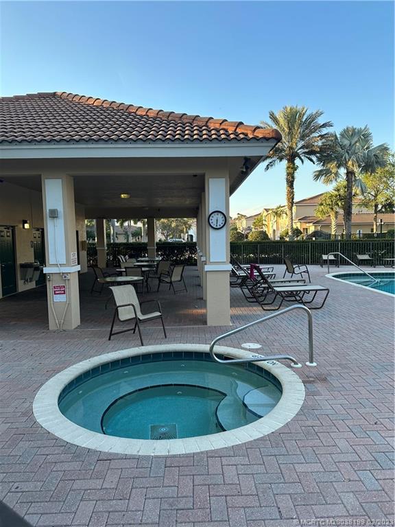 270 Southwest Walking Path Stuart, FL 34997 - Photo 21 of 25 a dinning table and chairs in patio of a house