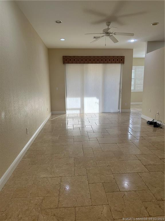 270 Southwest Walking Path Stuart, FL 34997 - Photo 4 of 25 a view of a livingroom with wooden floor and a window
