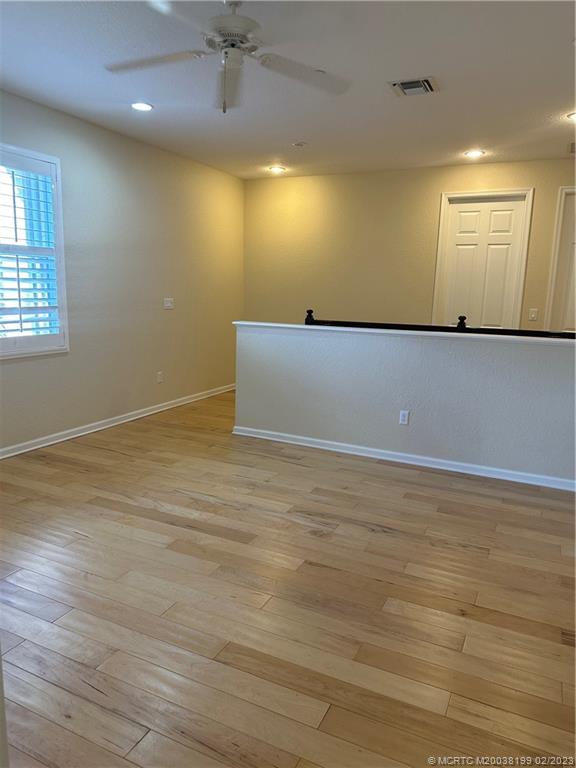 270 Southwest Walking Path Stuart, FL 34997 - Photo 9 of 25 an empty room with wooden floor and windows
