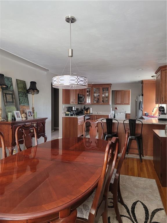 414 Hancock Avenue Vandergrift, PA 15690 - Photo 8 of 16 a view of a dining room with furniture a kitchen and chandelier