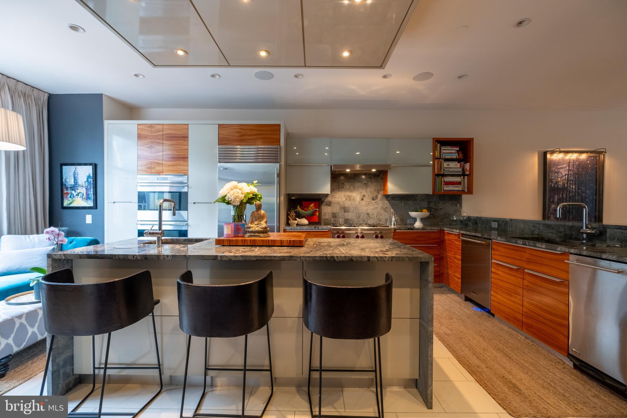 136 North 22nd Street Philadelphia, PA 19103 - Photo 15 of 78 a kitchen with stainless steel appliances granite countertop a sink and a large window