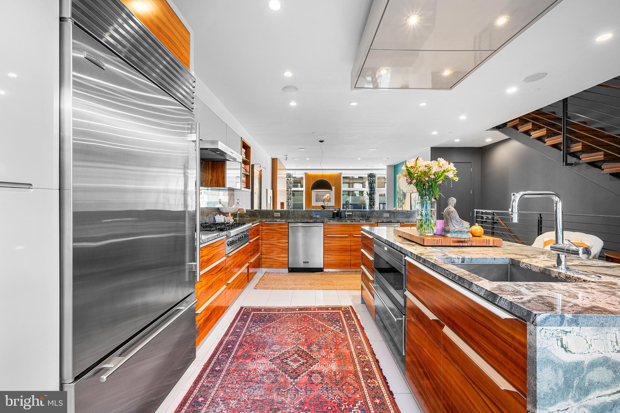 136 North 22nd Street Philadelphia, PA 19103 - Photo 16 of 78 a kitchen with stainless steel appliances granite countertop a sink and a refrigerator