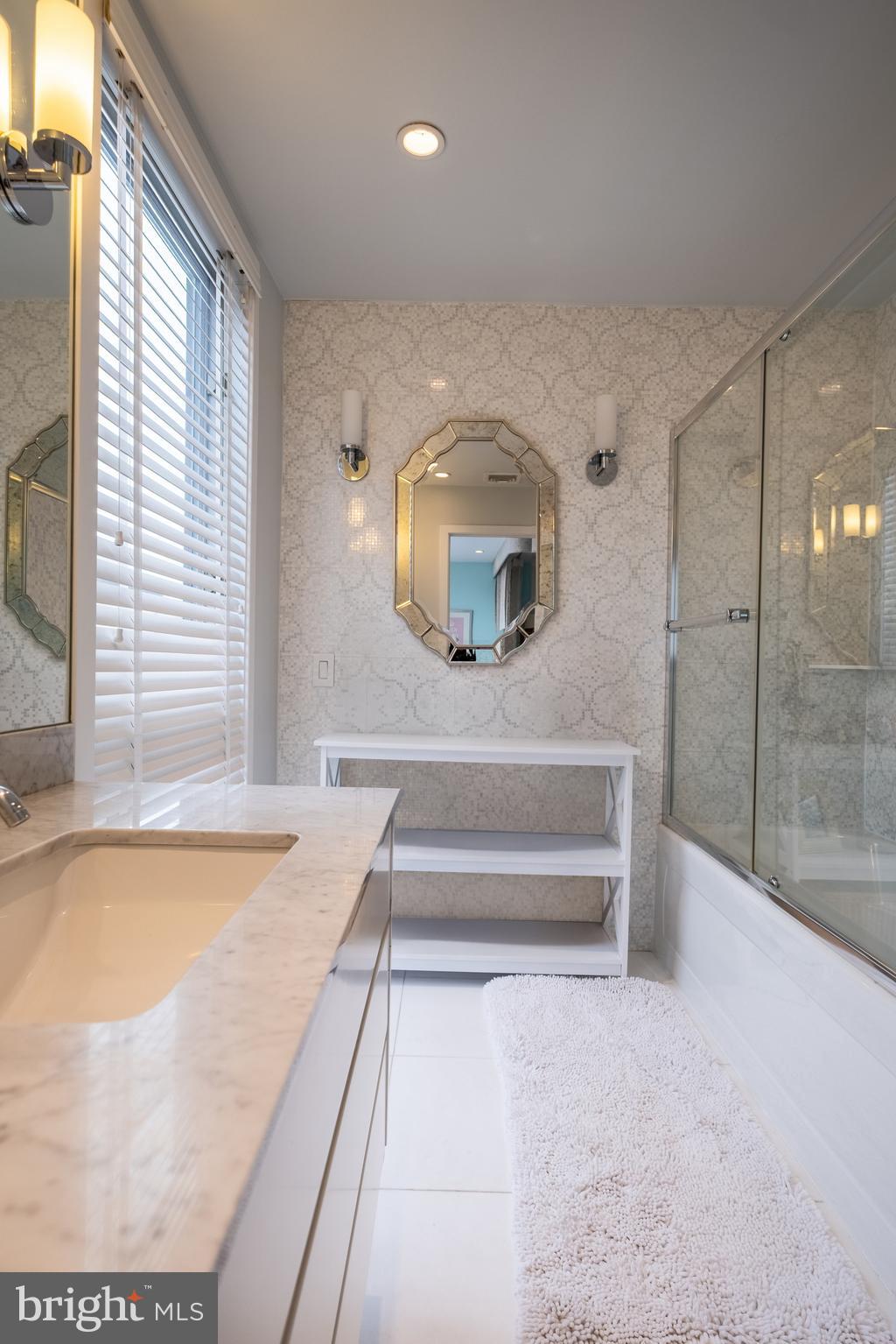 136 North 22nd Street Philadelphia, PA 19103 - Photo 46 of 78 a bathroom with a tub sink and mirror