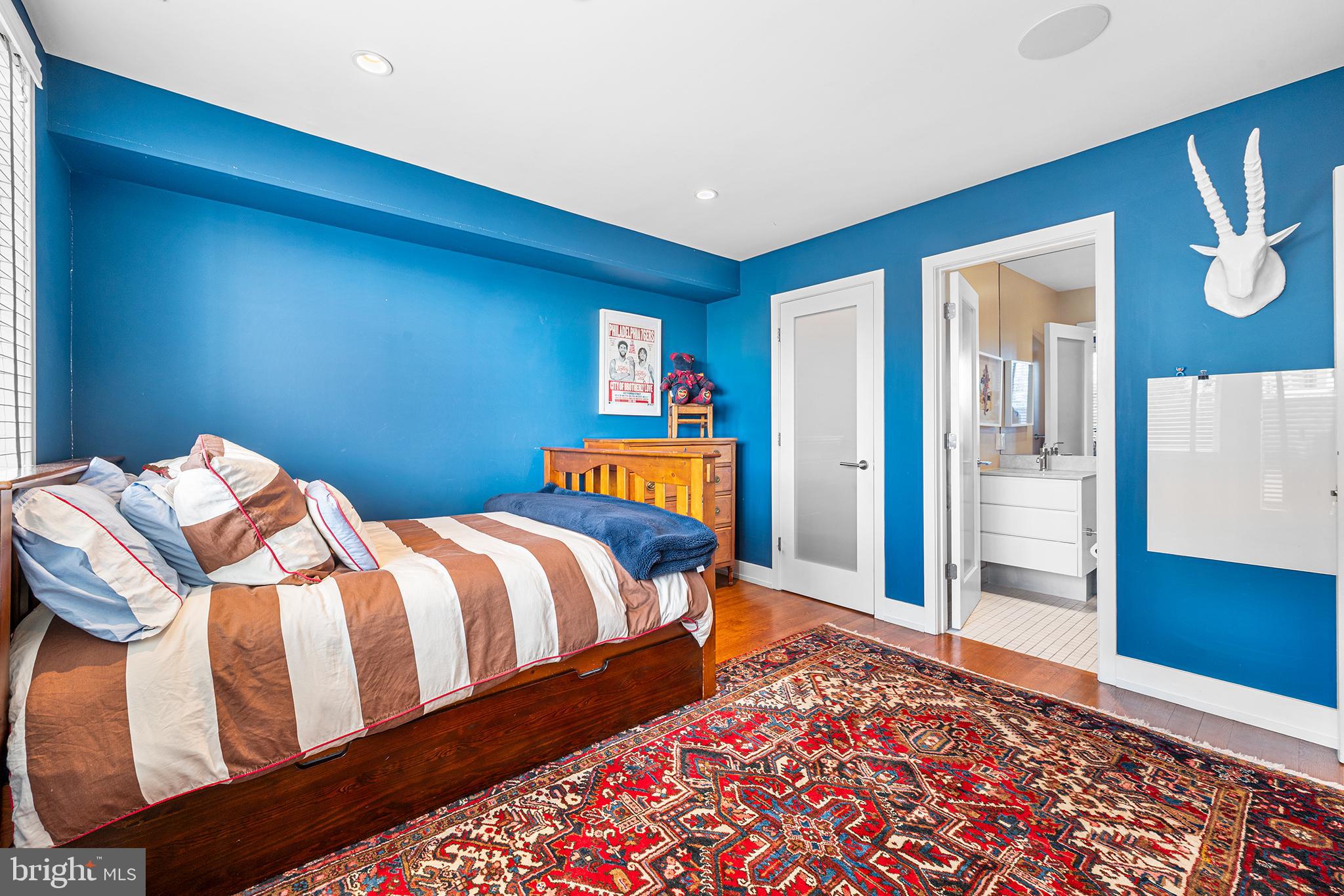 136 North 22nd Street Philadelphia, PA 19103 - Photo 50 of 78 a bedroom with three beds and painting on the wall