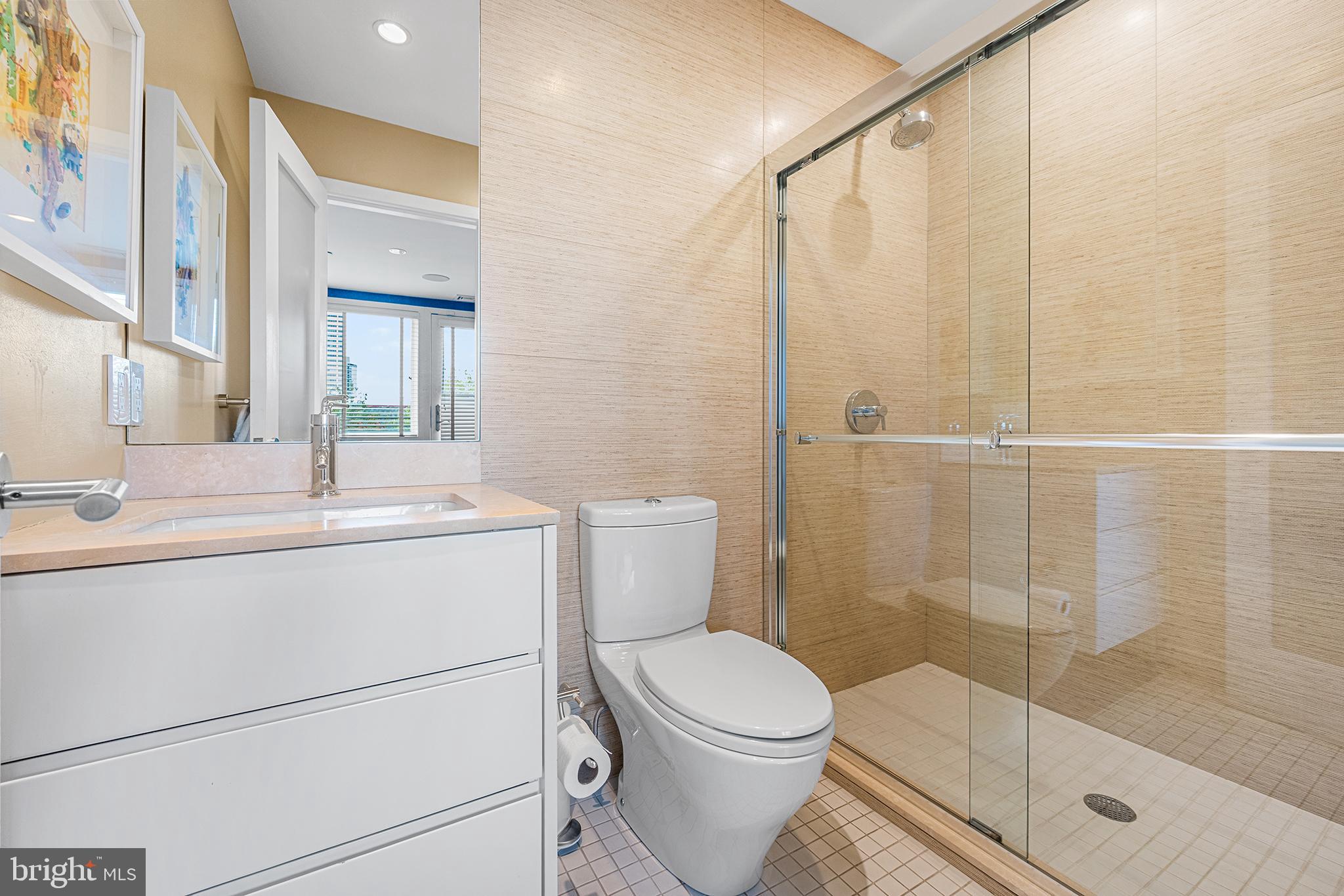 136 North 22nd Street Philadelphia, PA 19103 - Photo 51 of 78 a bathroom with a sink a mirror and a shower