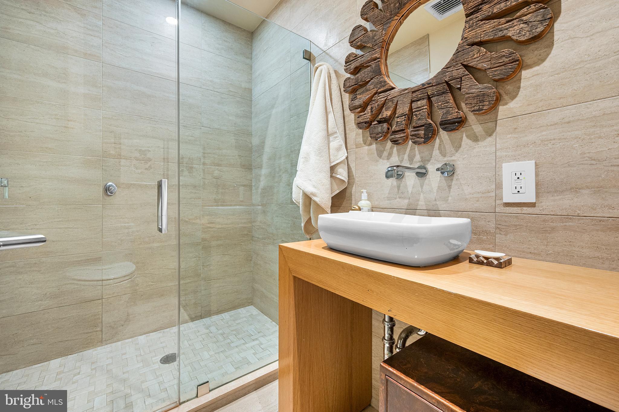 136 North 22nd Street Philadelphia, PA 19103 - Photo 7 of 78 a bathroom with a sink and mirror