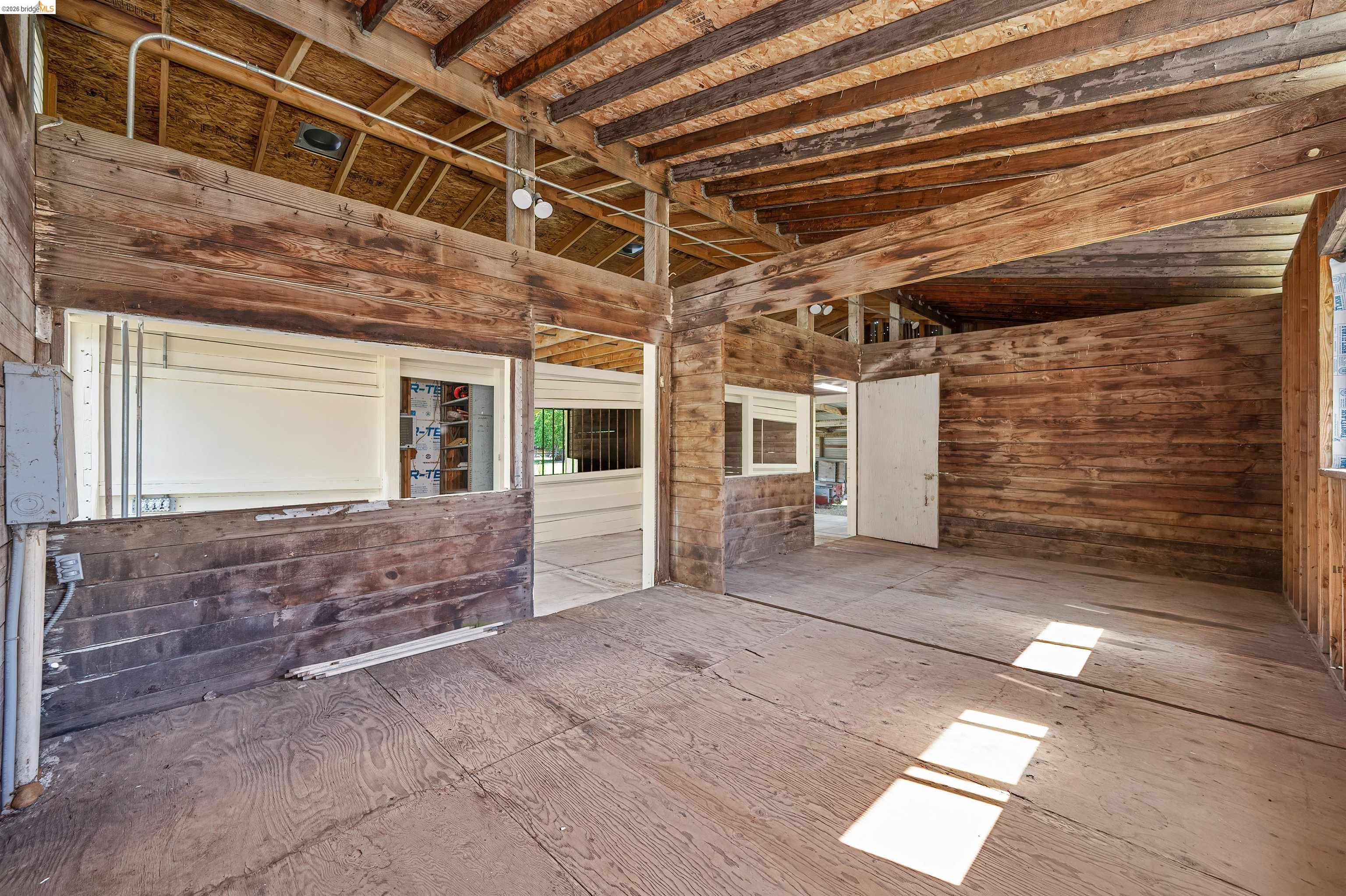 10474 Sheldon Road Elk Grove, CA 95624 - Photo 57 of 83 Exposed wood beam ceiling and wall construction, with plywood flooring