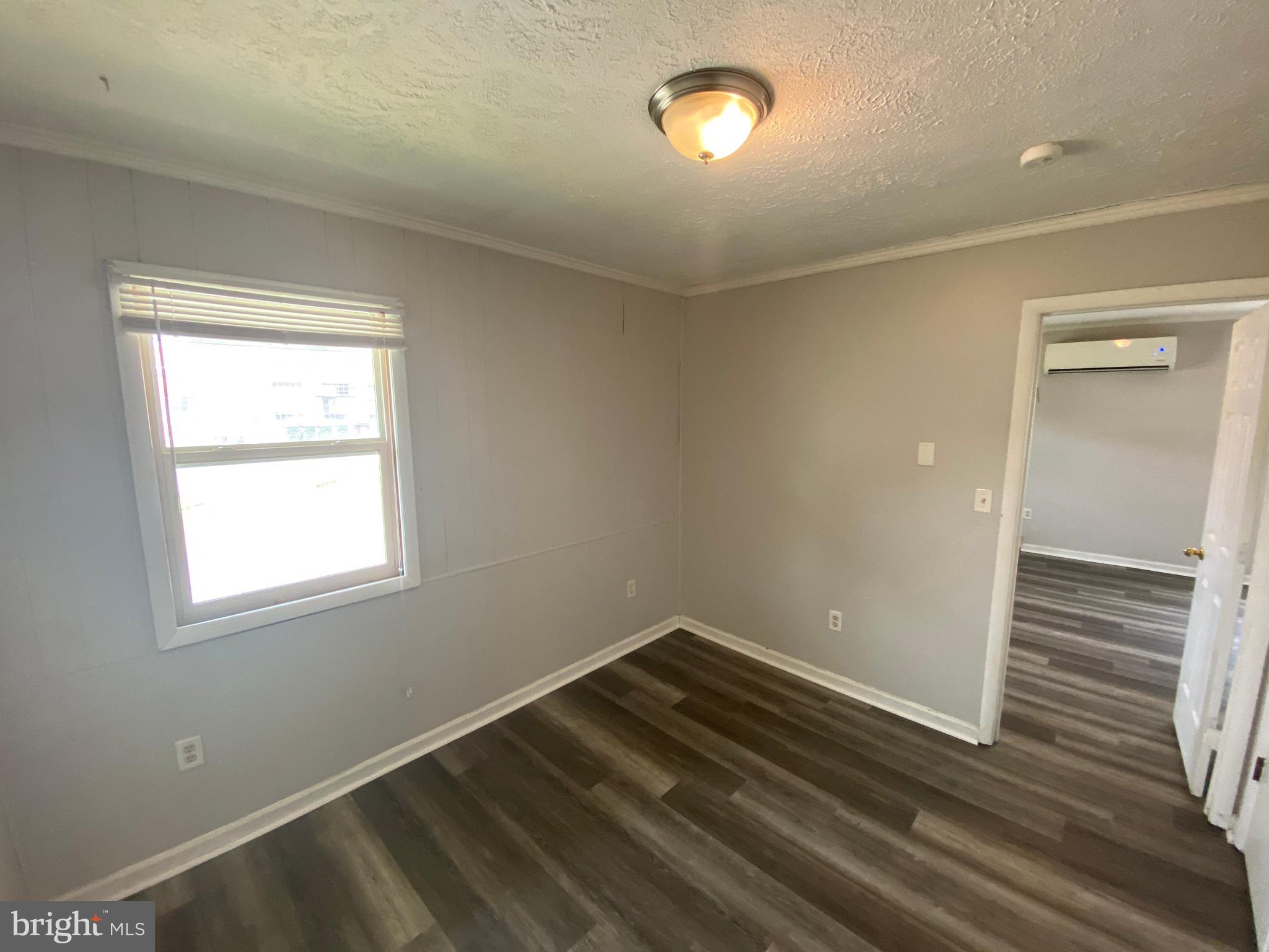 201 North Irving Avenue, Unit D Colonial Beach, VA 22443 - Photo 7 of 10 an empty room with a window