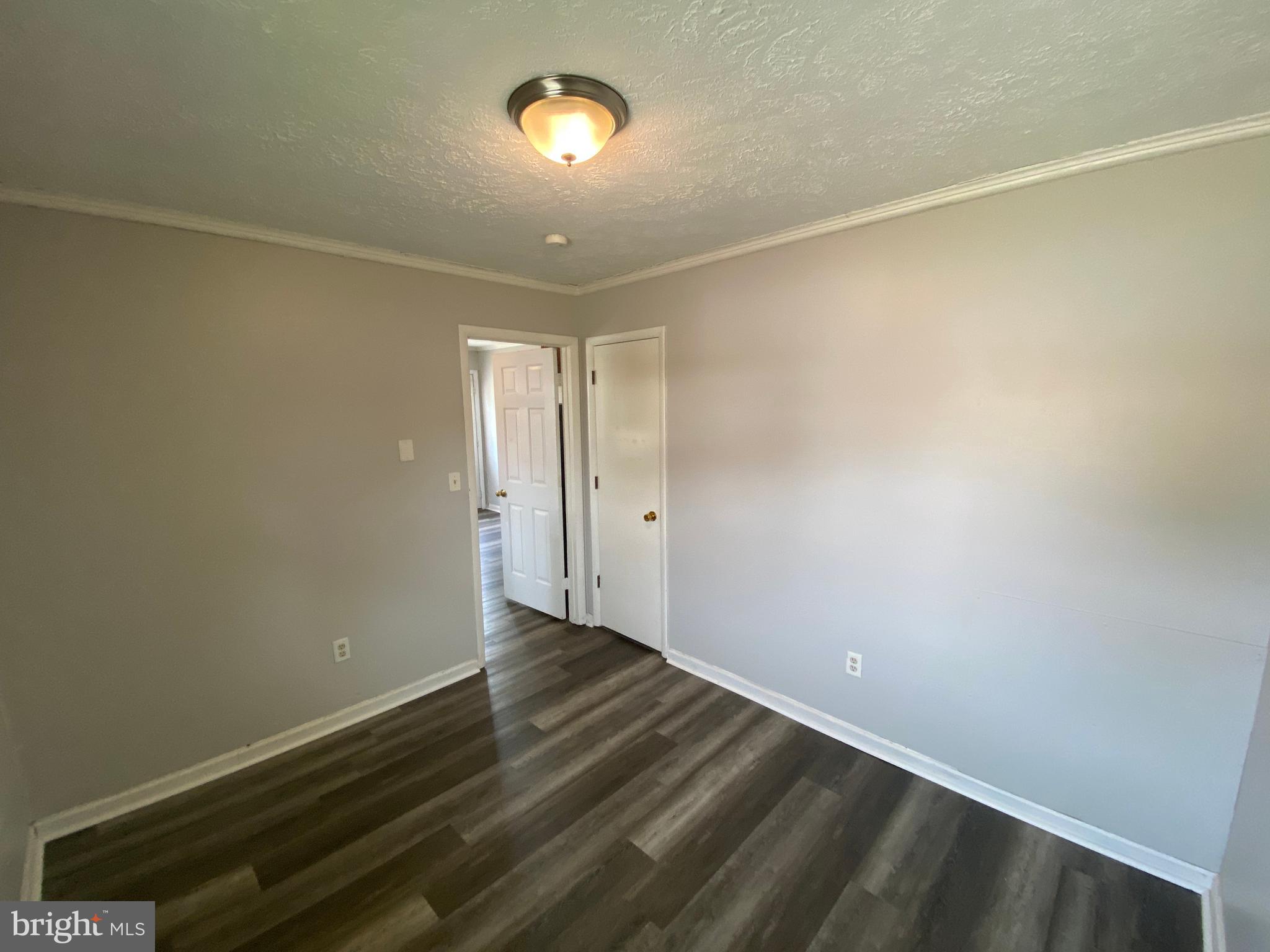 201 North Irving Avenue, Unit D Colonial Beach, VA 22443 - Photo 8 of 10 a view of an empty room with wooden floor