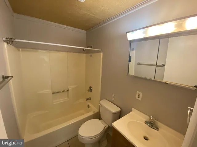 a bathroom with a sink mirror toilet and shower