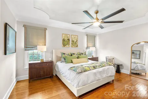 a bedroom with a bed couch and a window