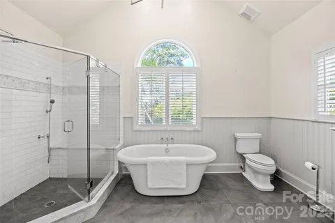 a spacious bathroom with a bathtub and a shower