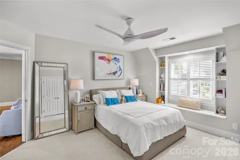 a bedroom with a bed and a large window