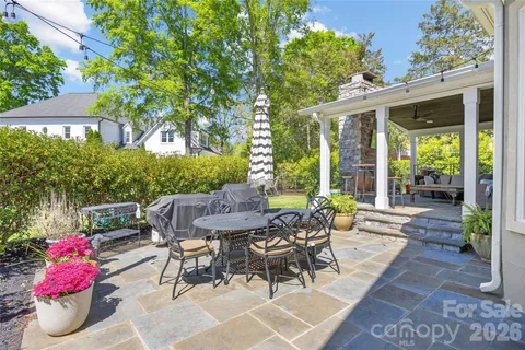 a view of a patio with a table and chairs and potted plants