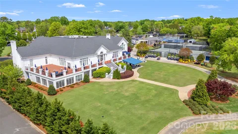 an aerial view of a house with a garden and lake view