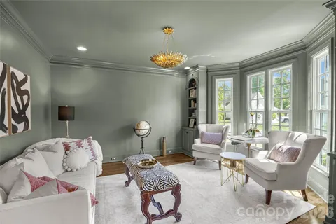 a living room with furniture and a chandelier
