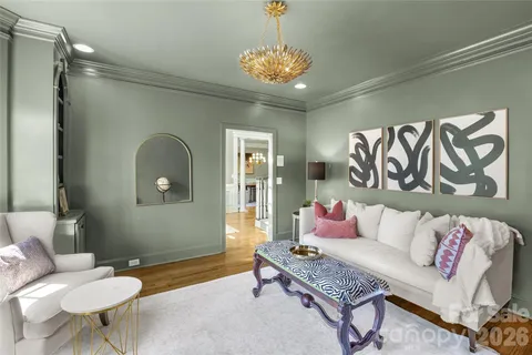 a living room with furniture and a chandelier