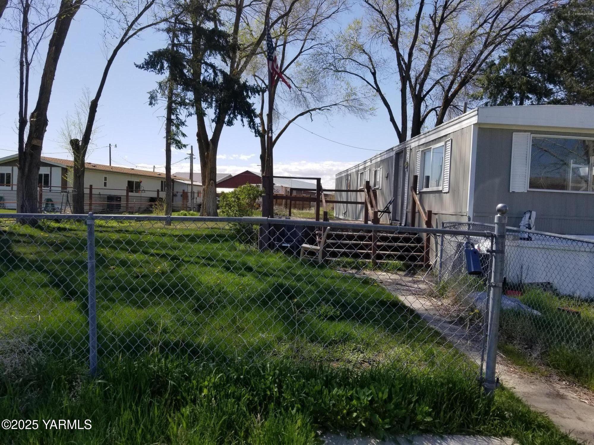 a view of a yard with large trees