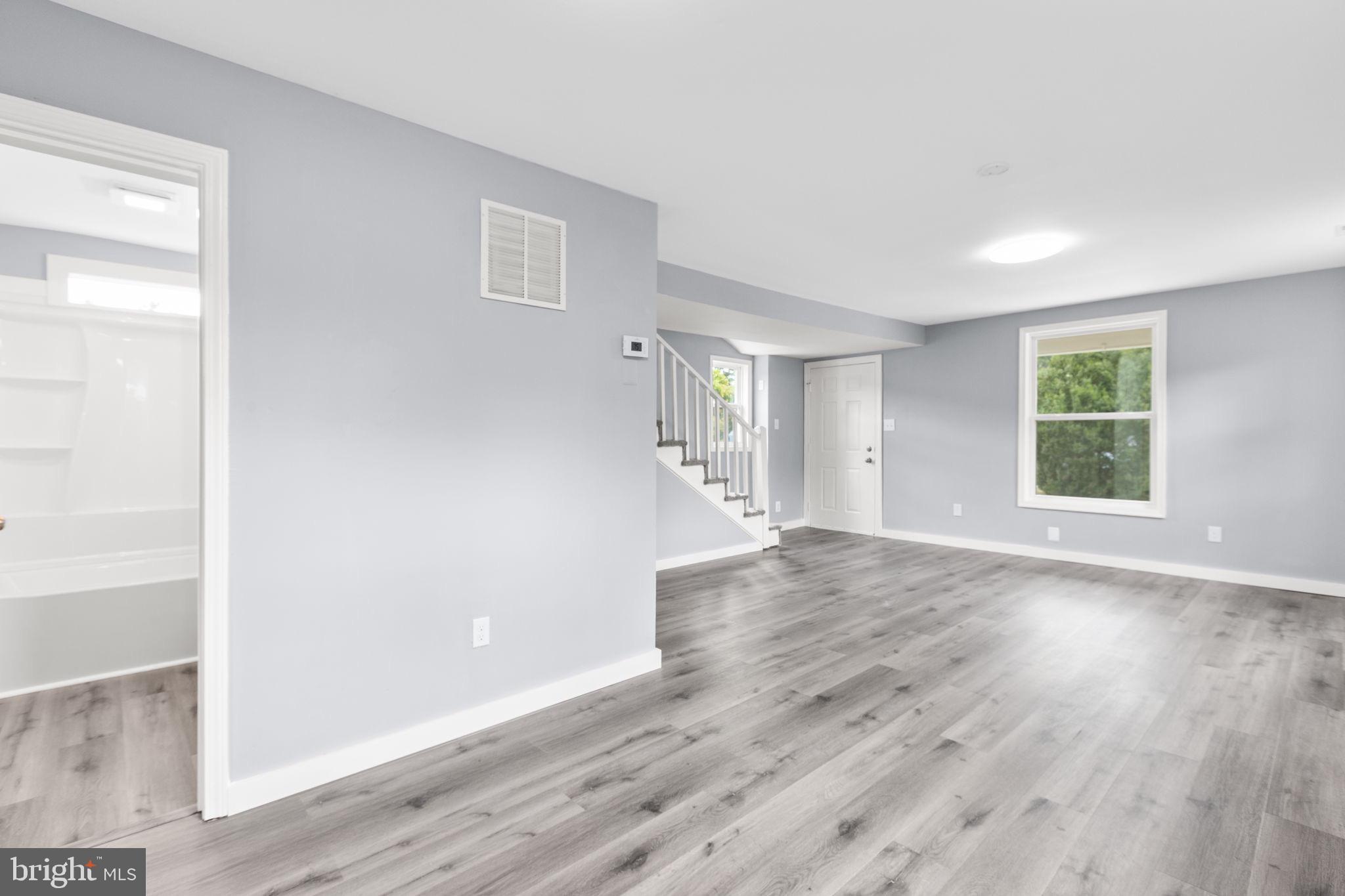 9113 Thornton Rolling Road Fredericksburg, VA 22408 - Photo 15 of 31 an empty room with wooden floor and windows