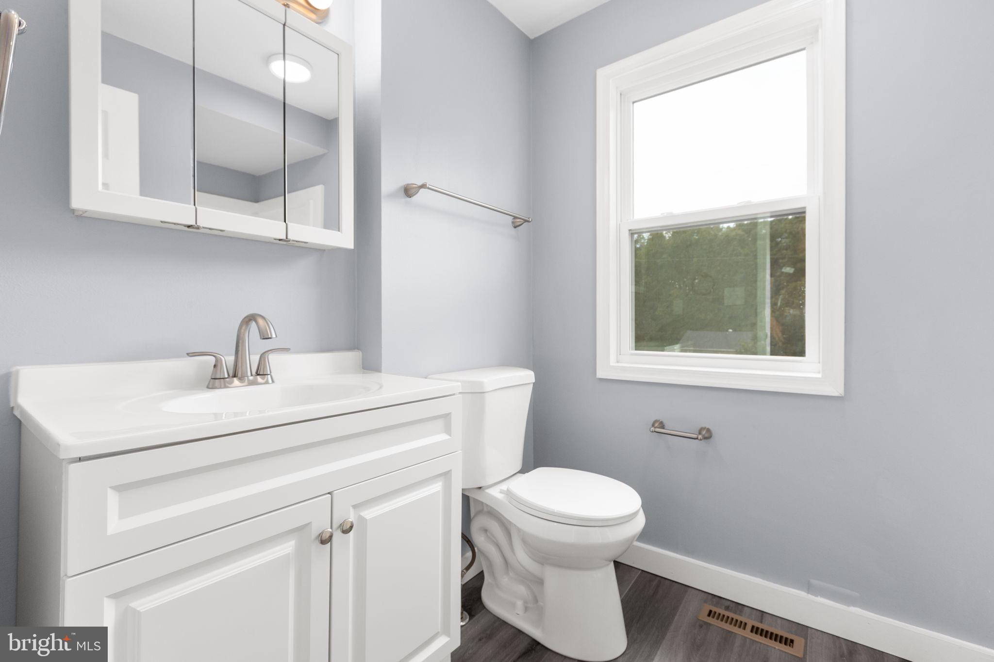9113 Thornton Rolling Road Fredericksburg, VA 22408 - Photo 23 of 31 a bathroom with a toilet sink and window