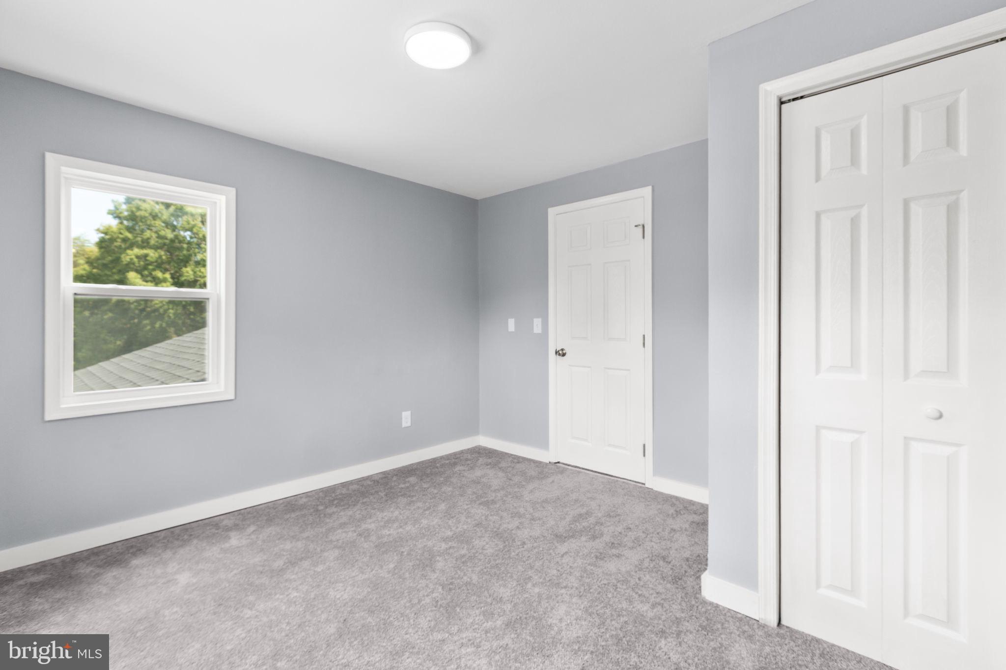 9113 Thornton Rolling Road Fredericksburg, VA 22408 - Photo 25 of 31 an empty room with windows and closet