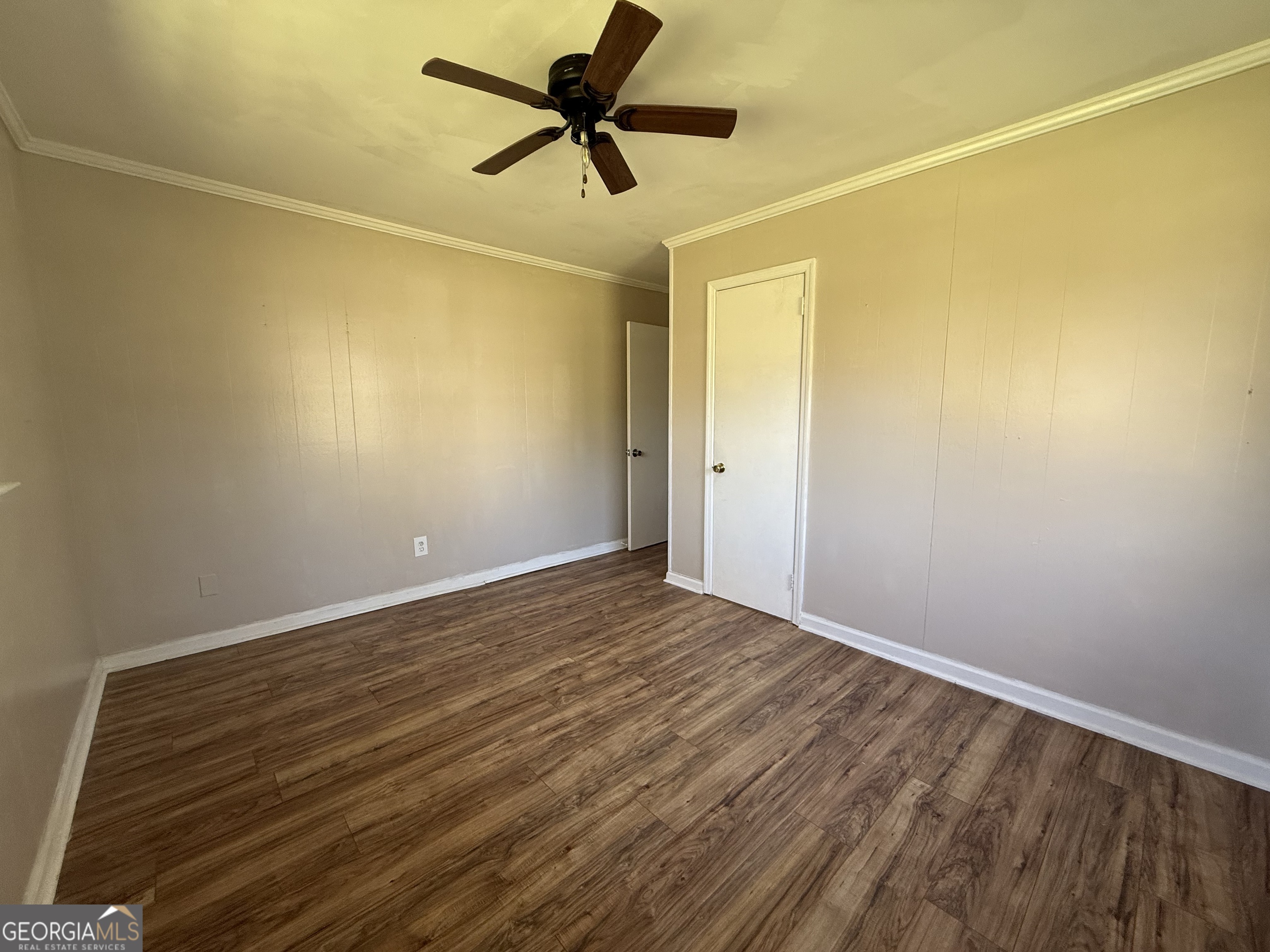 28 Brewer Road Jewell, GA 31045 - Photo 16 of 27 a view of a room with wooden floor and a ceiling fan
