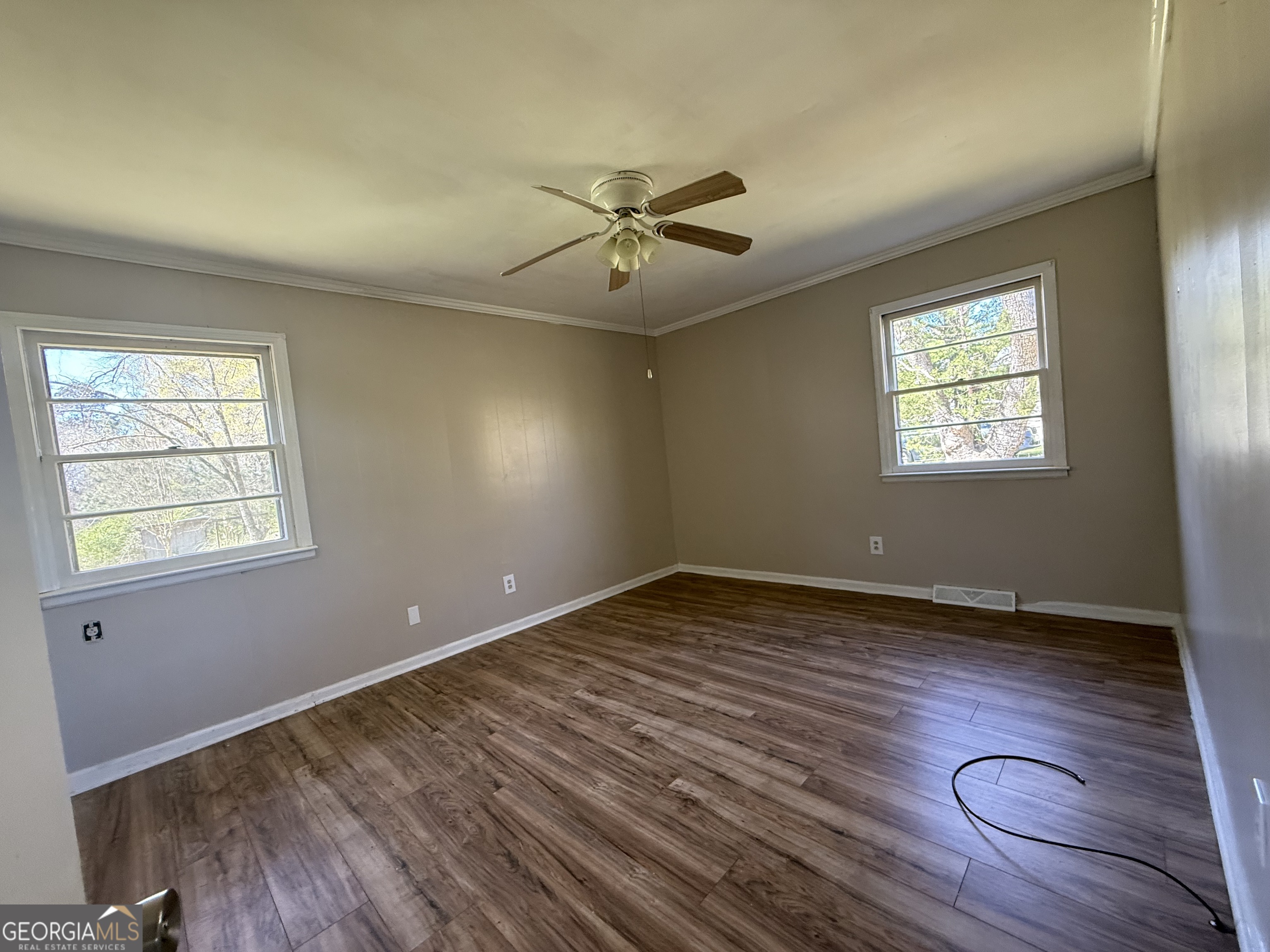 28 Brewer Road Jewell, GA 31045 - Photo 9 of 27 a view of an empty room with wooden floor and a window