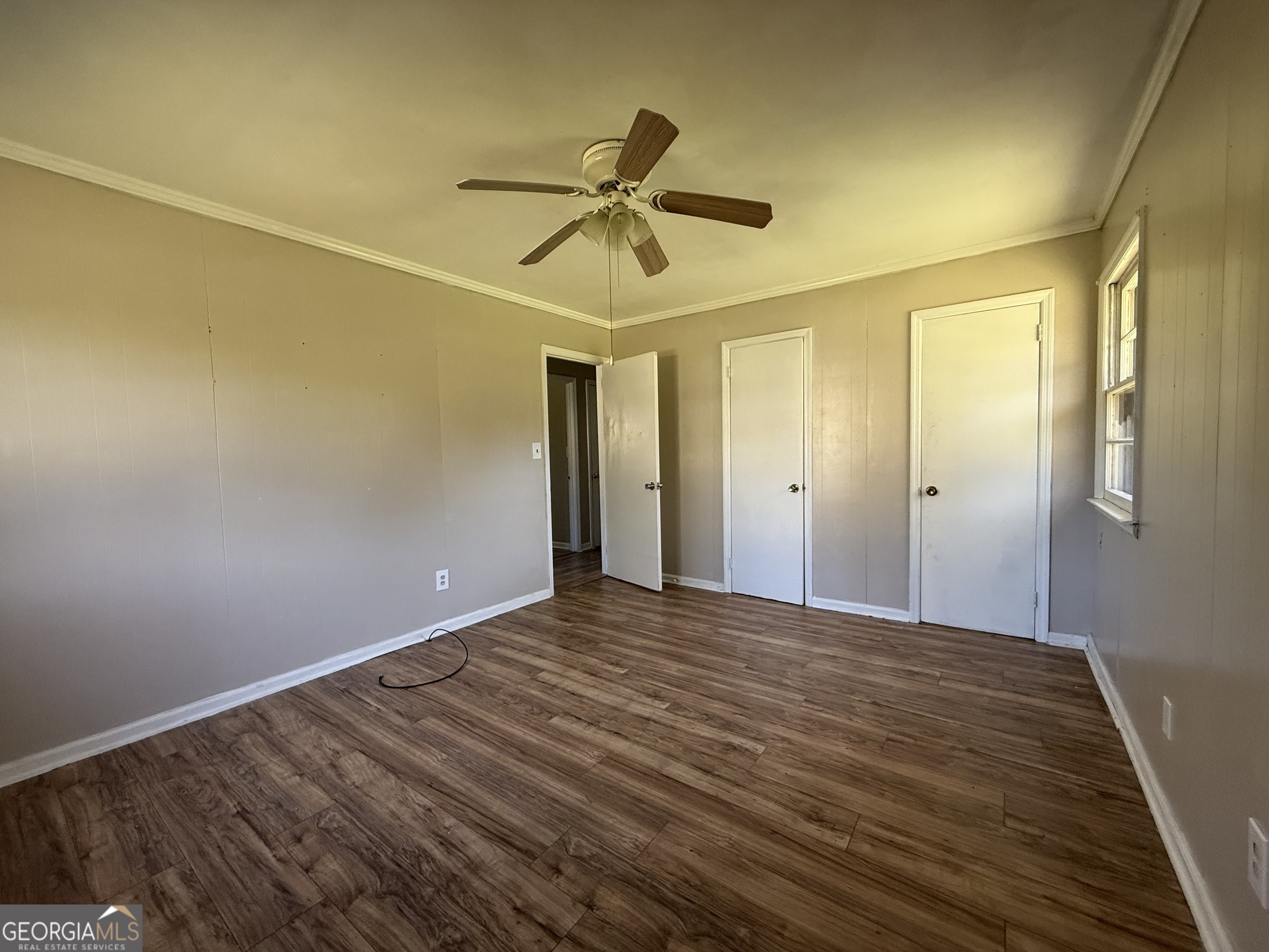 28 Brewer Road Jewell, GA 31045 - Photo 10 of 27 a view of empty room with wooden floor and fan