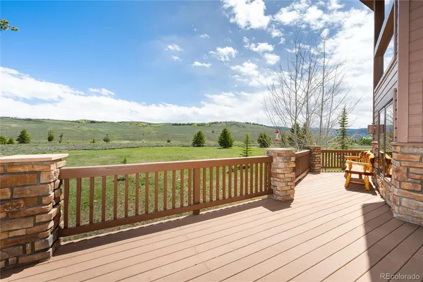 a view of a swimming pool with a yard from inside of the house