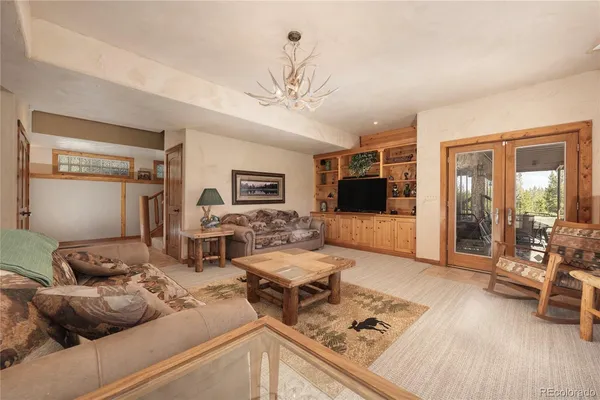 a room with pool table and windows