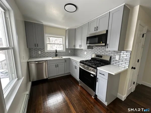 a kitchen with a stove sink and a microwave
