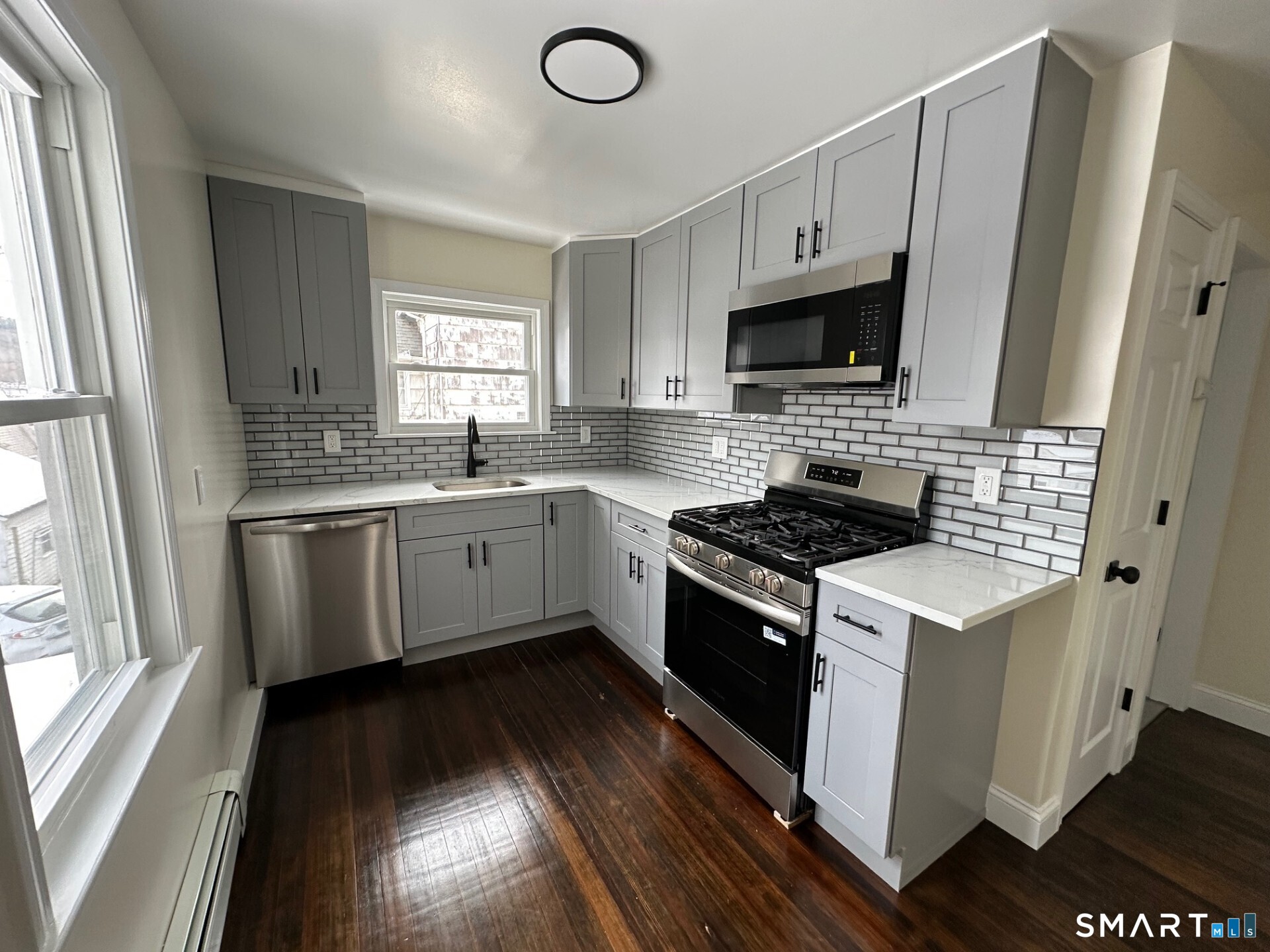 713 South Main Street Torrington, CT 06790 - Photo 2 of 10 a kitchen with a stove sink and a microwave