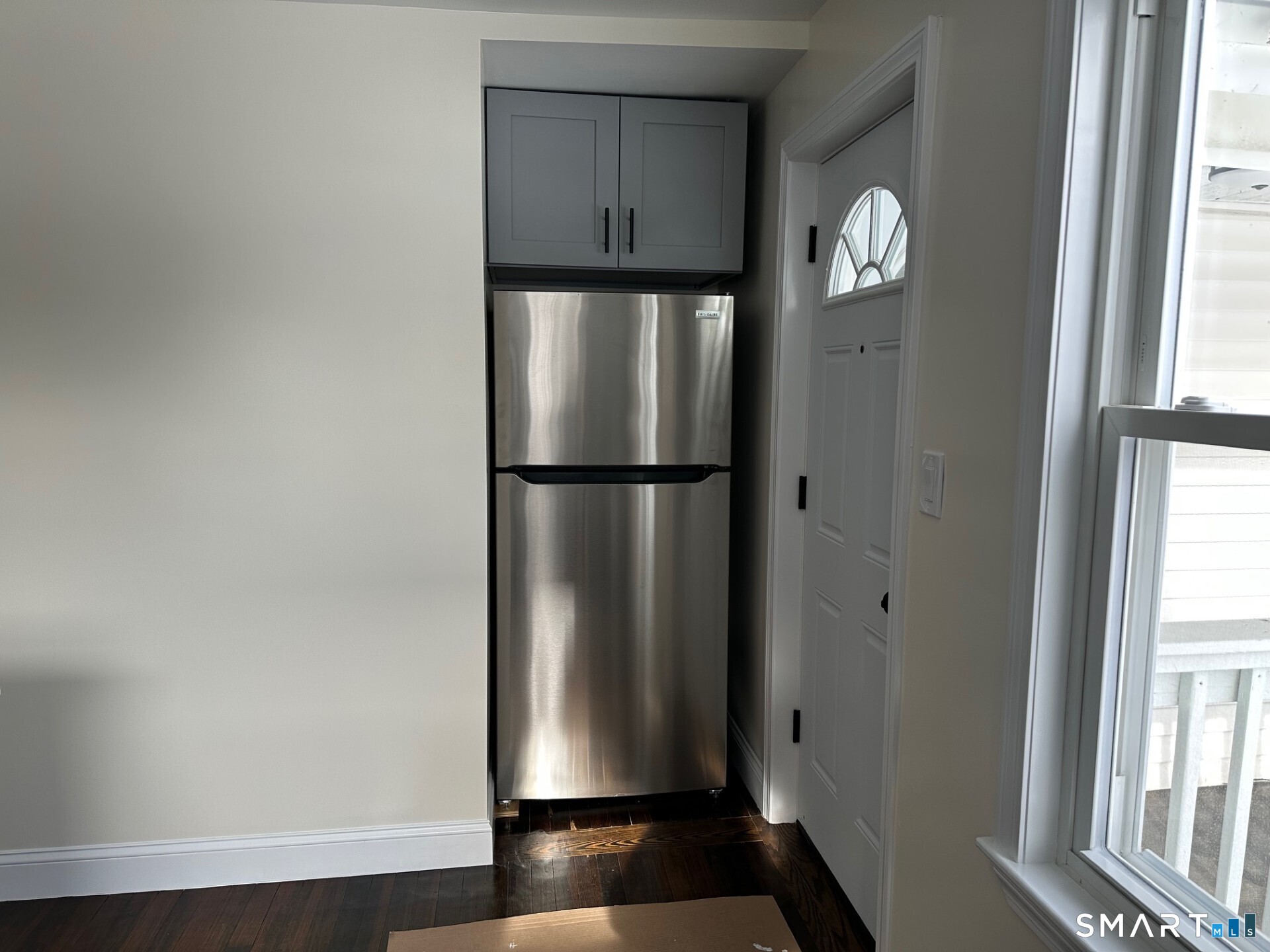 713 South Main Street Torrington, CT 06790 - Photo 4 of 10 a view of empty room with windows and refrigerator