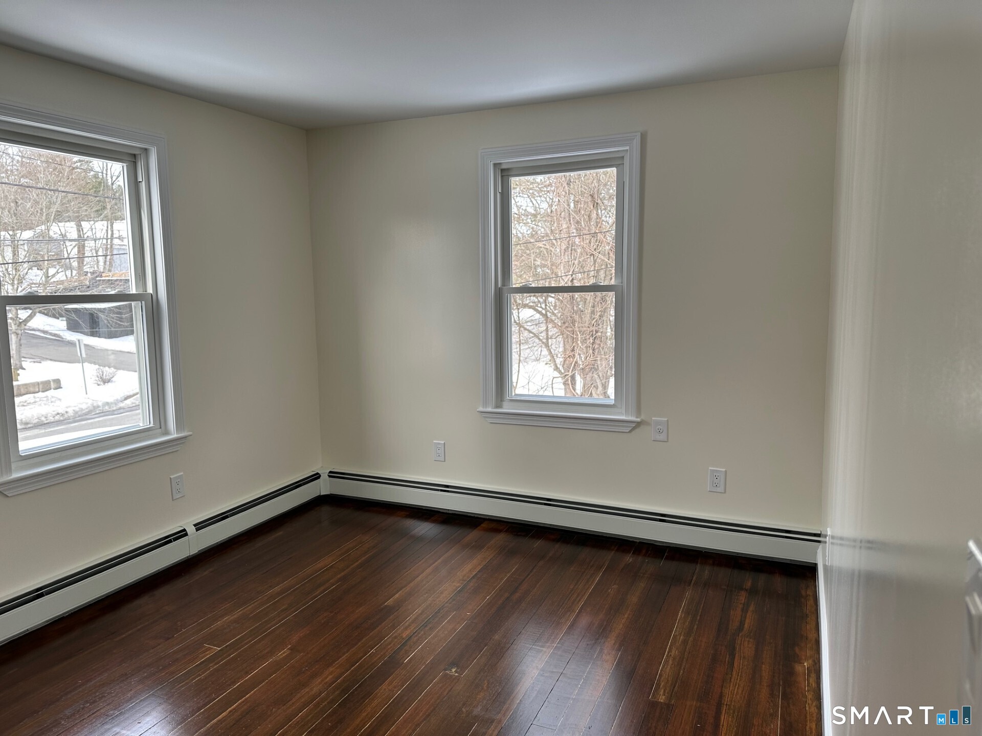 713 South Main Street Torrington, CT 06790 - Photo 9 of 10 an empty room with wooden floor and windows