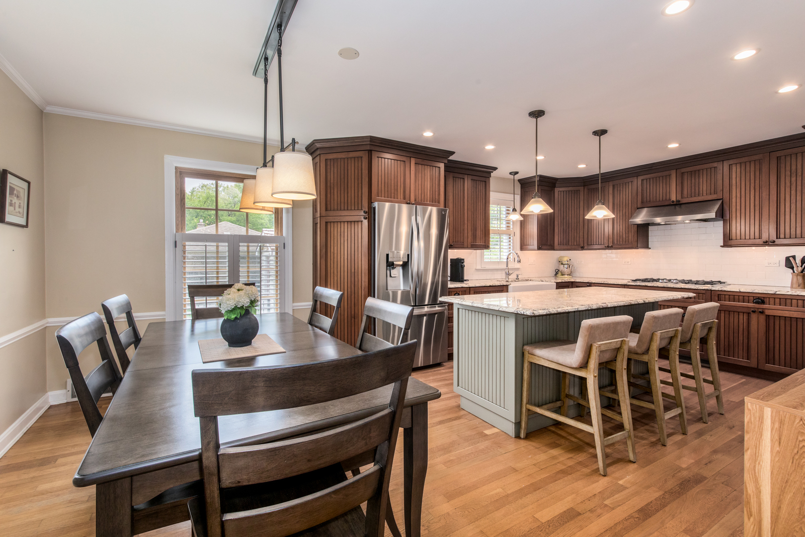 1116 South Aldine Avenue Park Ridge, IL 60068 - Photo 6 of 31 a kitchen with a dining table chairs stainless steel appliances and cabinets