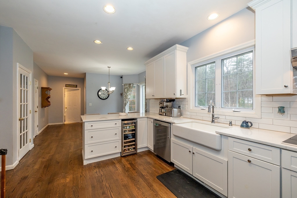 142 River Road Pepperell, MA 01463 - Photo 11 of 41 a kitchen with a white stove cabinets and wooden floor