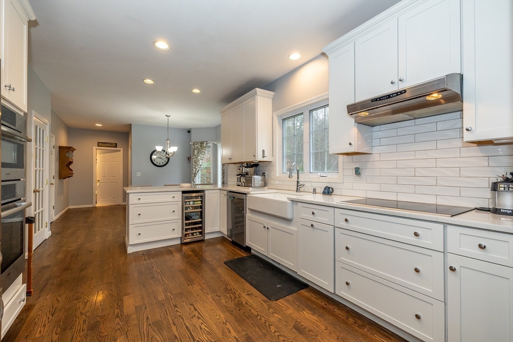 142 River Road Pepperell, MA 01463 - Photo 13 of 41 a kitchen with cabinets and wooden floor