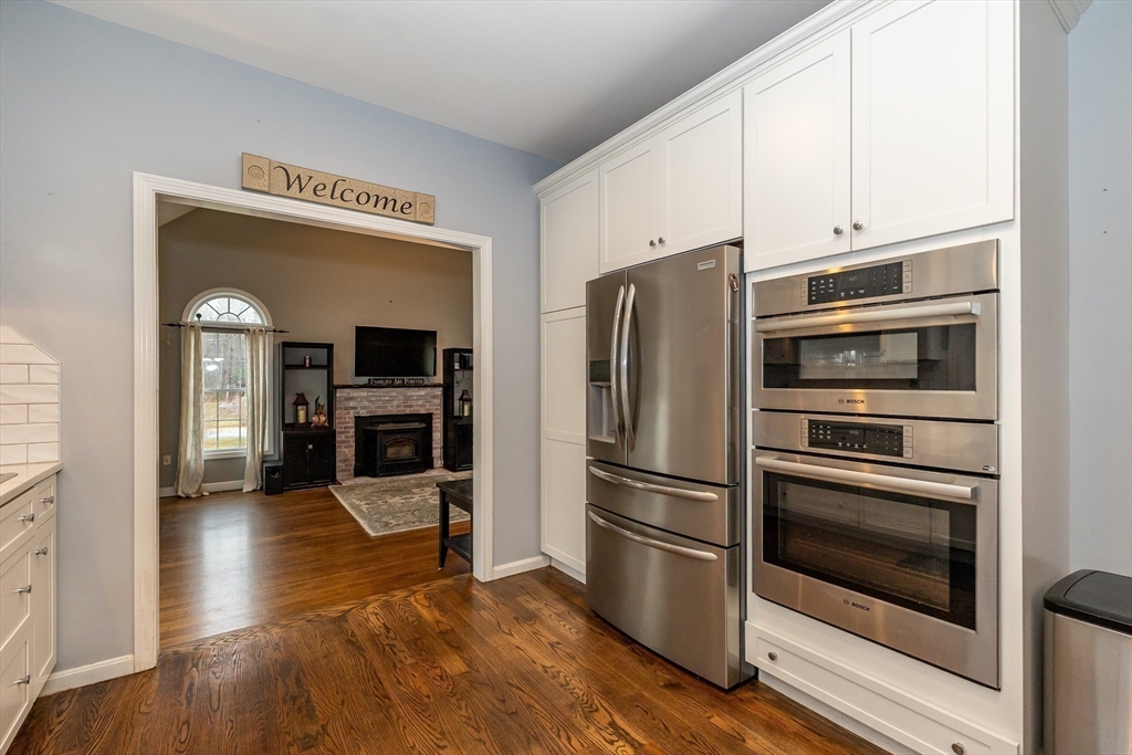 142 River Road Pepperell, MA 01463 - Photo 14 of 41 a kitchen with granite countertop a refrigerator and a stove top oven