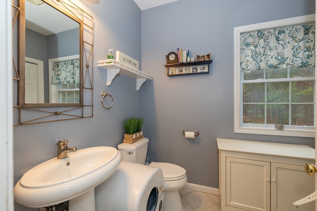 142 River Road Pepperell, MA 01463 - Photo 21 of 41 a bathroom with a toilet sink and mirror